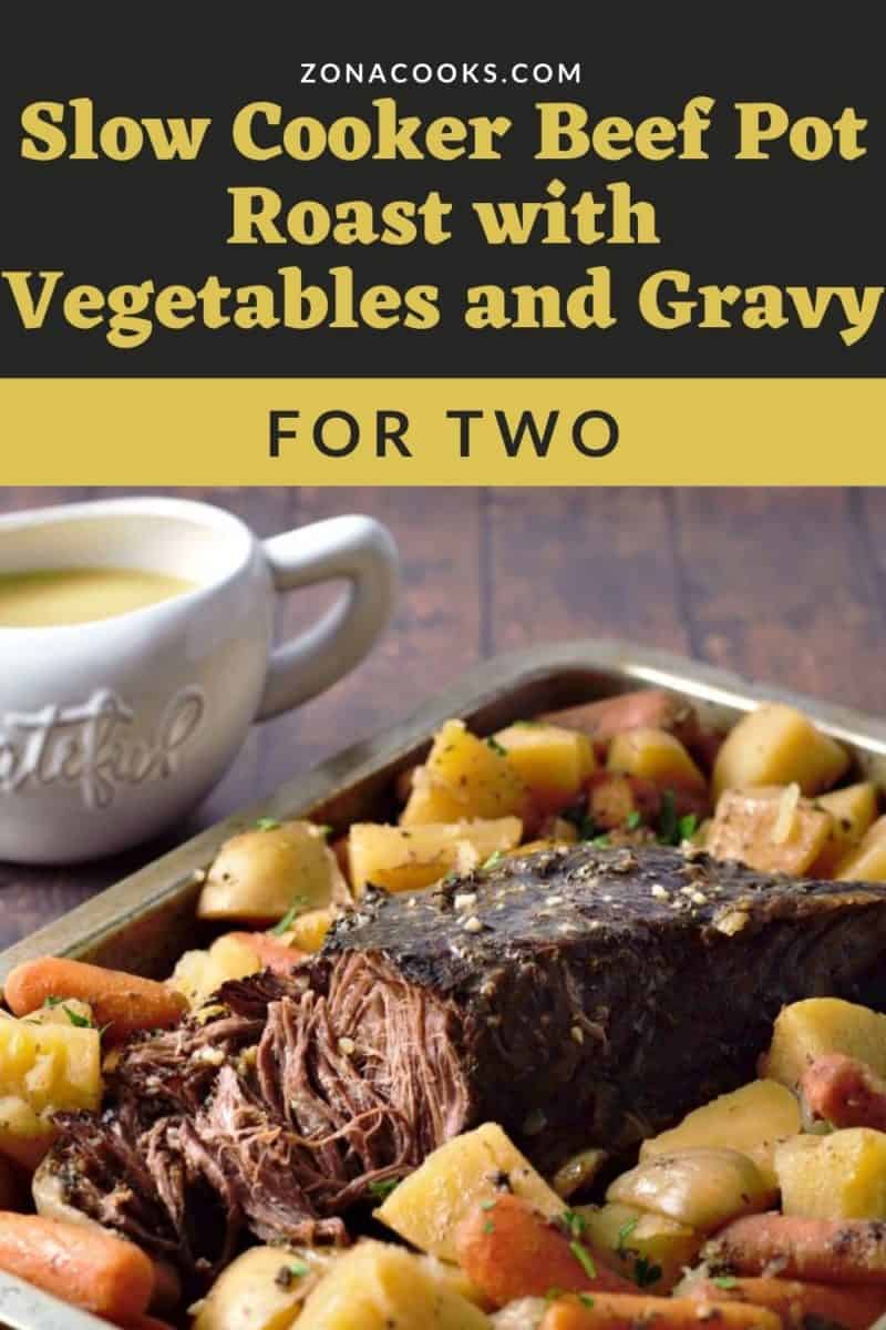 a beef pot roast and veggies on a tray with a side of gravy.