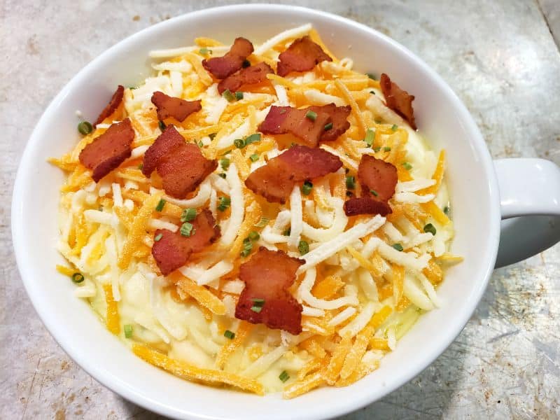 cheese and bacon on top of holiday mashed potato casserole