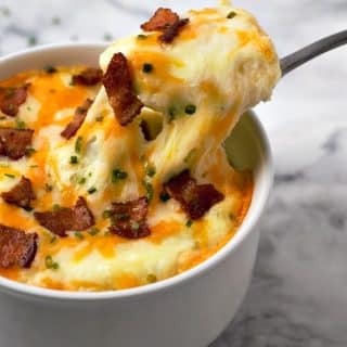 Mashed Potato Casserole with a spoon pulling a bite out