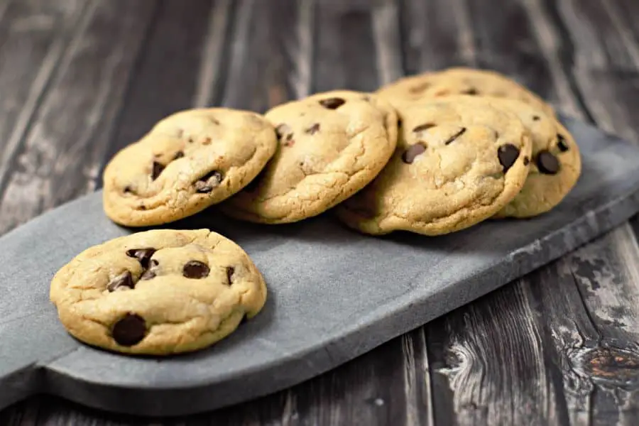6 Bakery Style Chocolate Chips Cookies on a cutting board