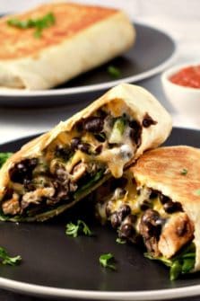 Crispy Chicken and Black Bean Chimichanga cut open on a plate.