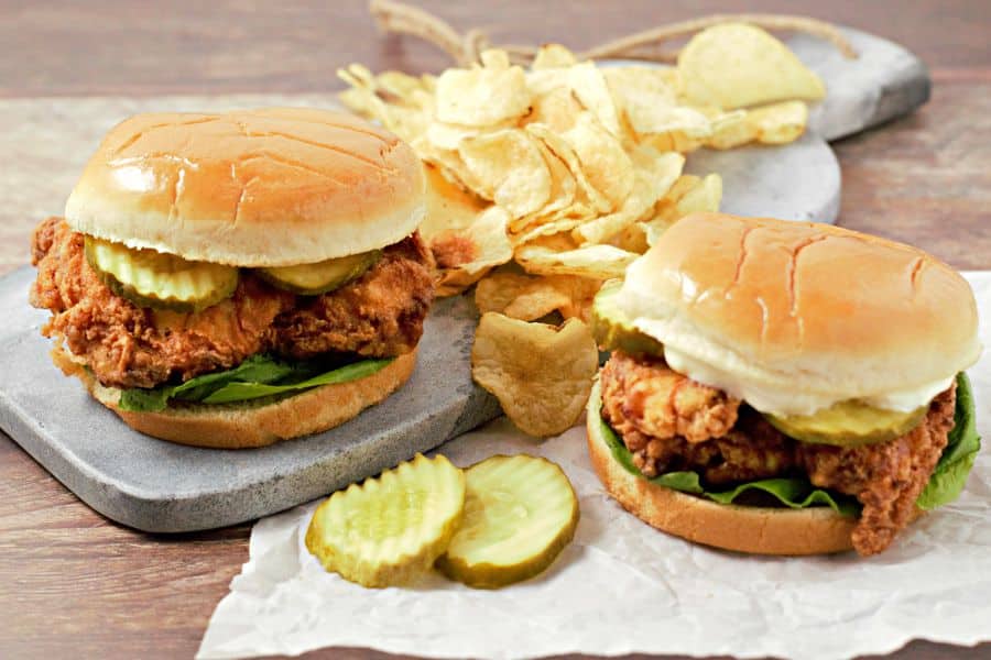Two Buttermilk Fried Chicken Sandwiches with a side of chips