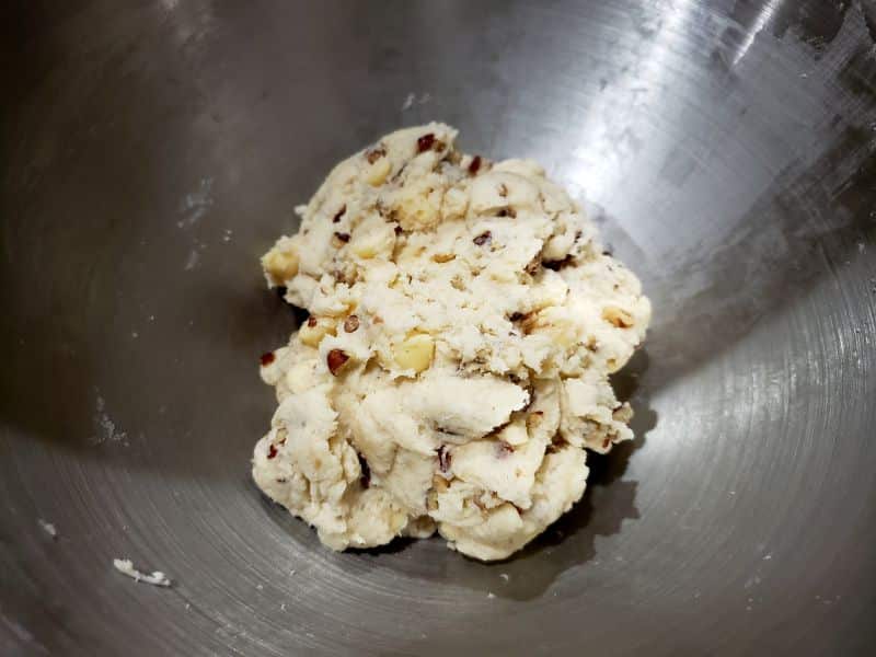 dough with white chocolate chips in a mixing bowl