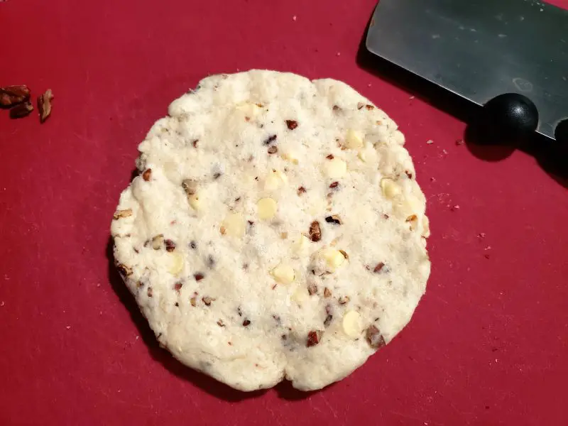 scone dough in a circle on a cutting board
