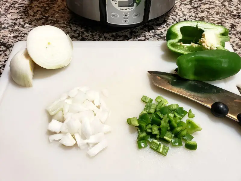 diced onion and green pepper on a cutting board