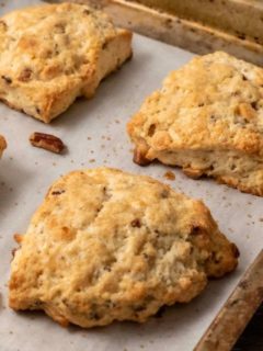 Butter Pecan White Chocolate Scones on a baking sheet.