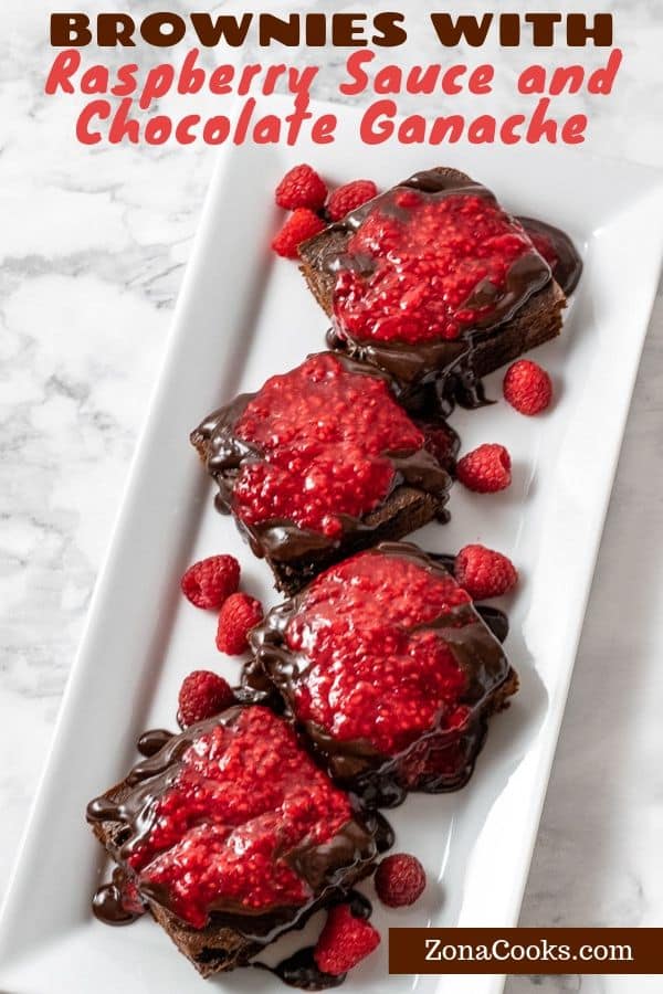 brownies with raspberry sauce and chocolate ganche on a platter.