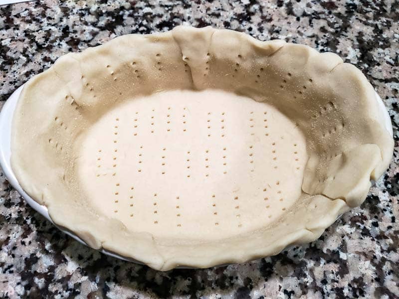 pie crust added to dish and poked with a fork.