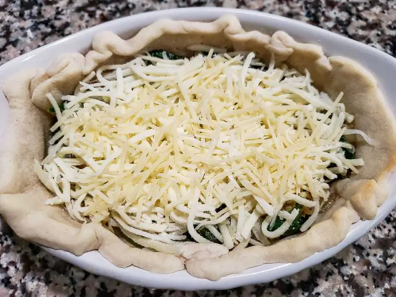 mozzarella and parmesan added to the spinach artichoke quiche in the pie crust.