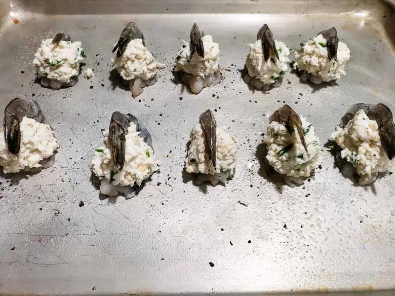 10 shrimp on a baking sheet stuffed with crab mixture
