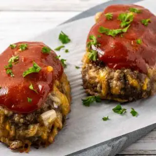 two little meatloaves on a cutting board