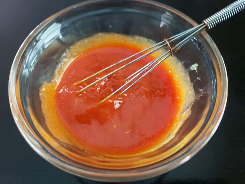 homemade BBQ sauce whisked in a bowl.
