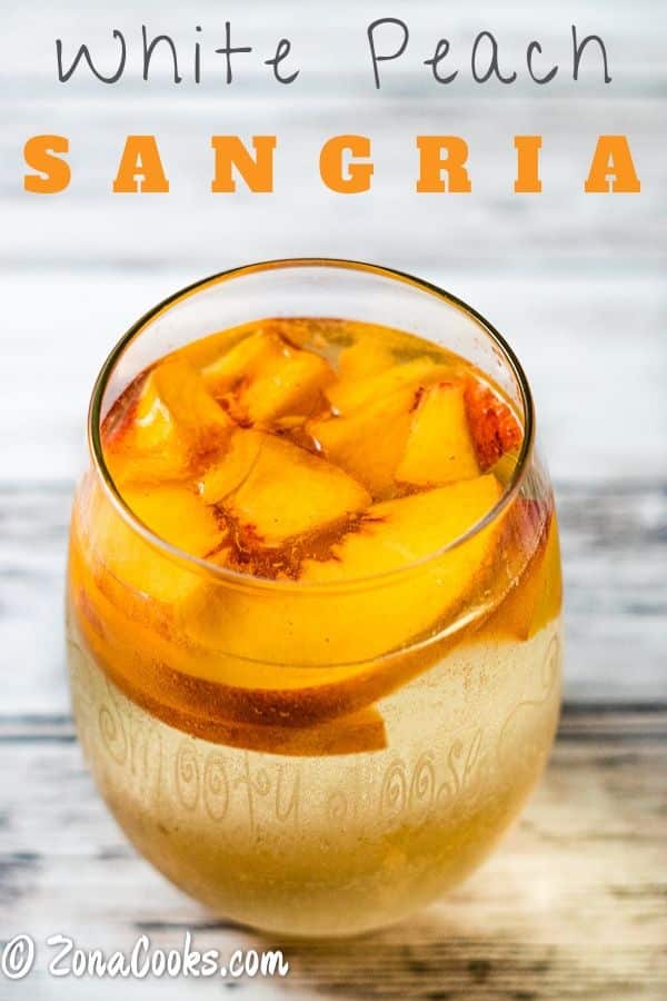 a glass of white peach sangria.