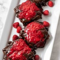 Brownies with Raspberry Sauce on a plate.