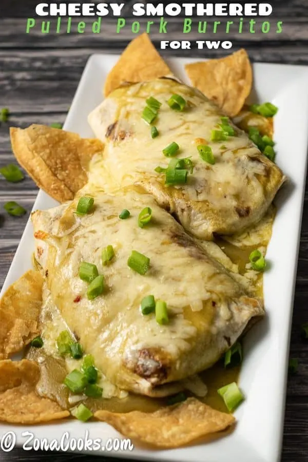 cheesy smothered pulled pork burritos for two with tortilla chips and green onions
