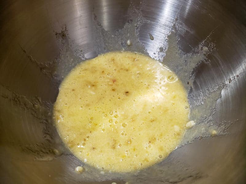 banana, egg, vanilla, sugar, and butter mixed in a bowl