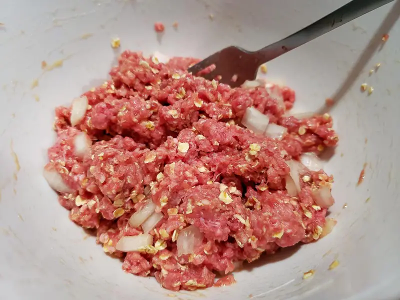 ground beef mixed with oats, salt, onion, and egg.