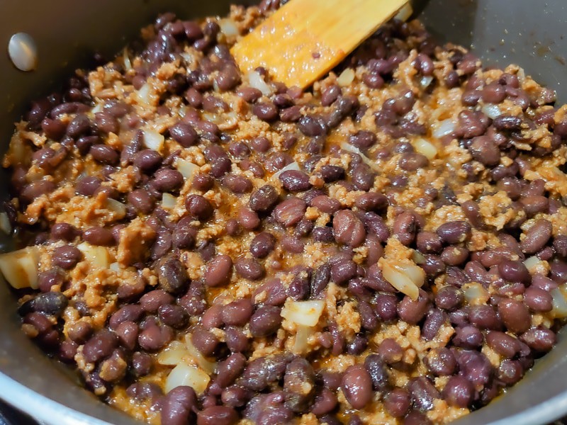 taco meat with black beans cooking in a pan