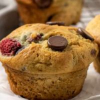 5 Raspberry Dark Chocolate Banana Bread Muffins on a plate and a wire rack.