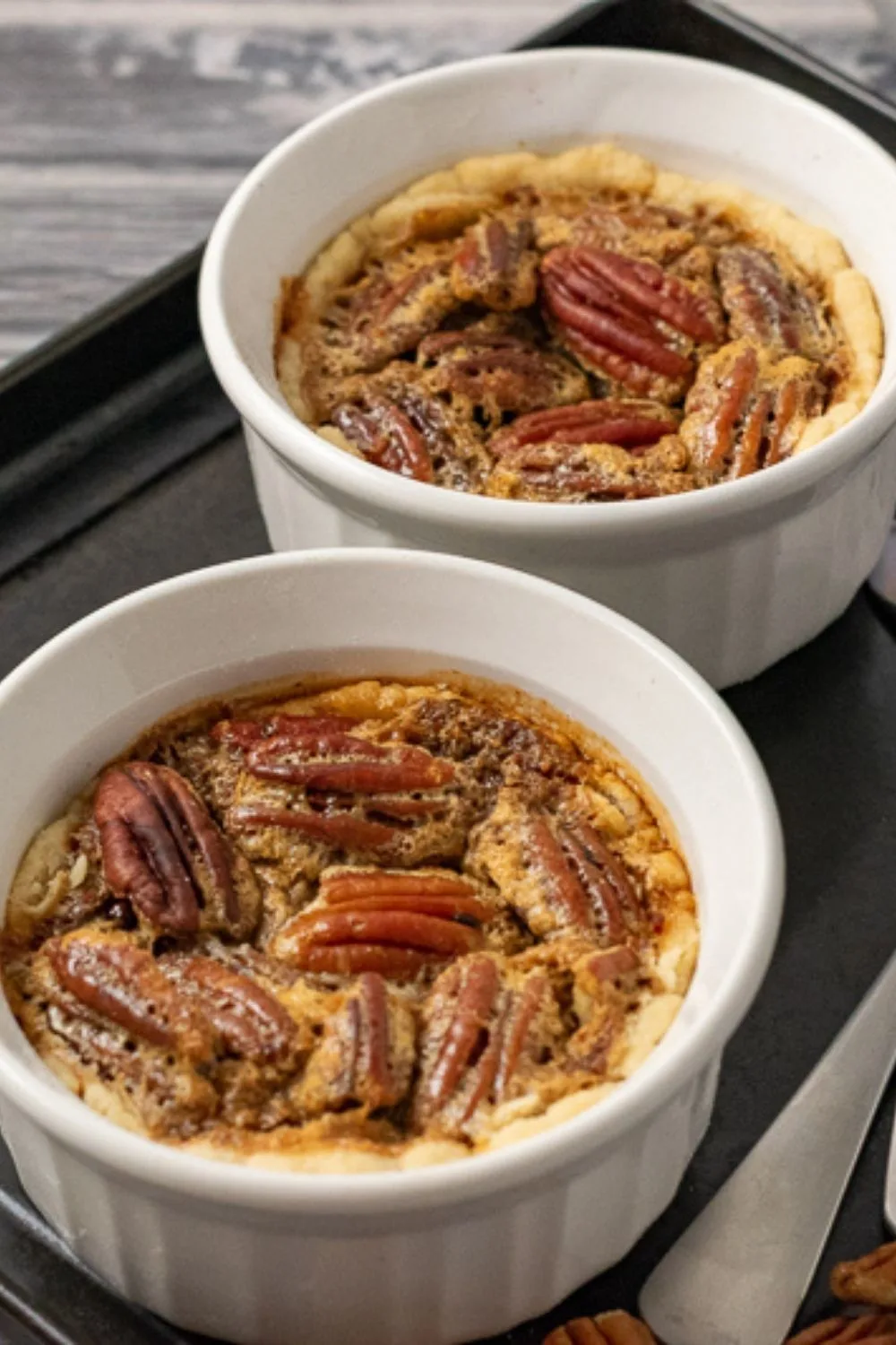 two Pecan Pies in ramekin dishes.