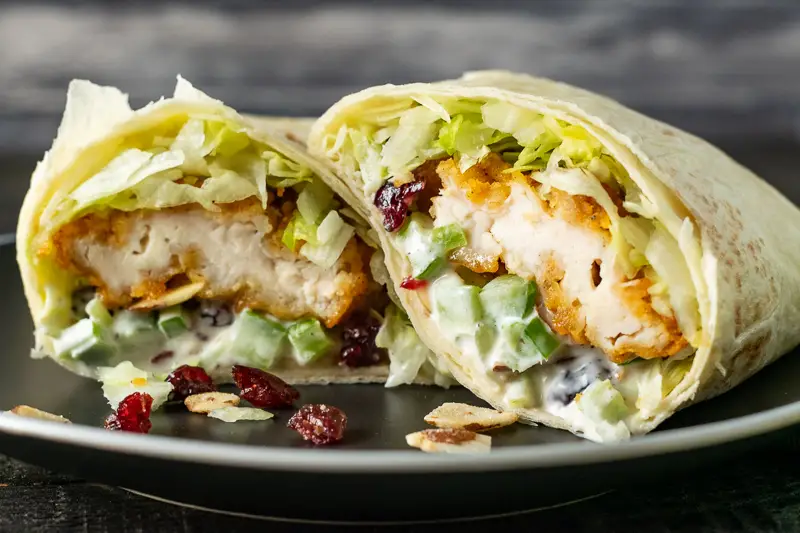 cranberry almond chicken salad wrap on a plate