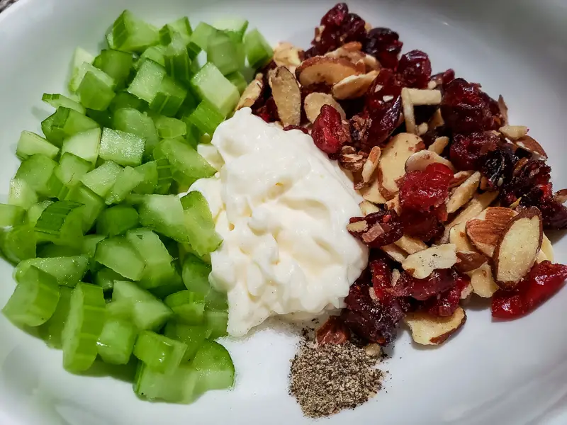 cranberry almond chicken salad ingredients in a bowl