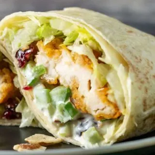 a Cranberry Almond Chicken Salad wrap on a plate.