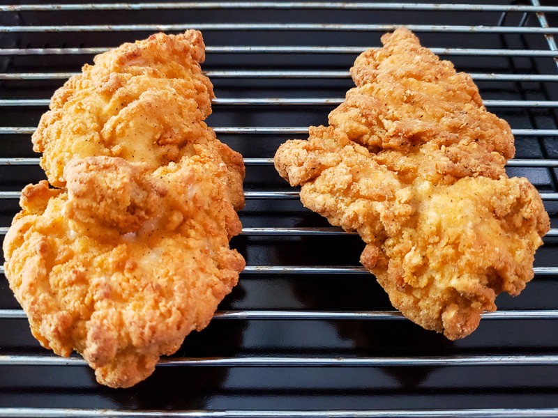 breaded crispy chicken cooling on a rack