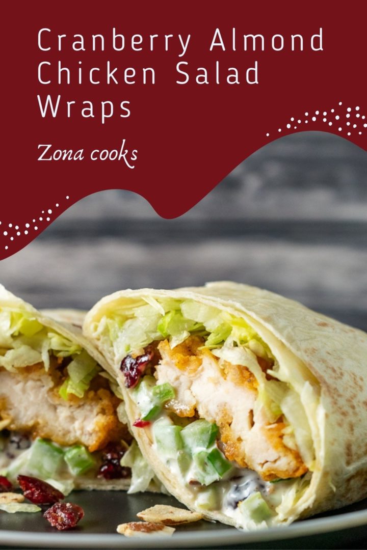 a crispy chicken wrap cut open on a plate.