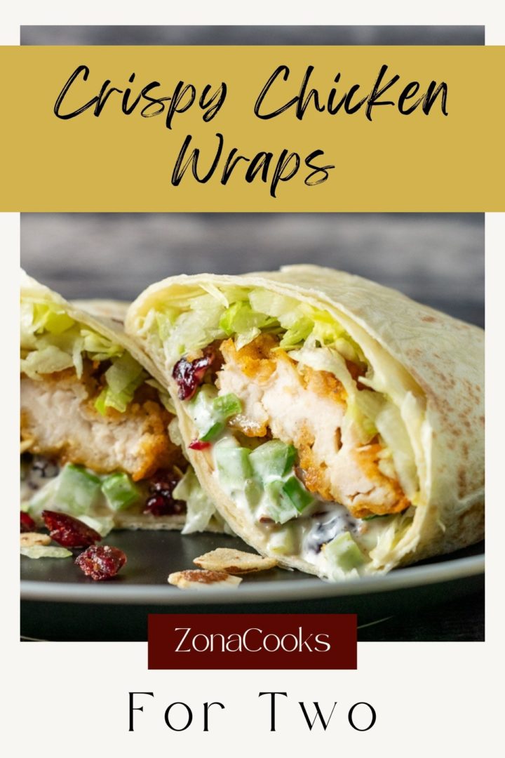 a crispy chicken wrap cut open on a plate.