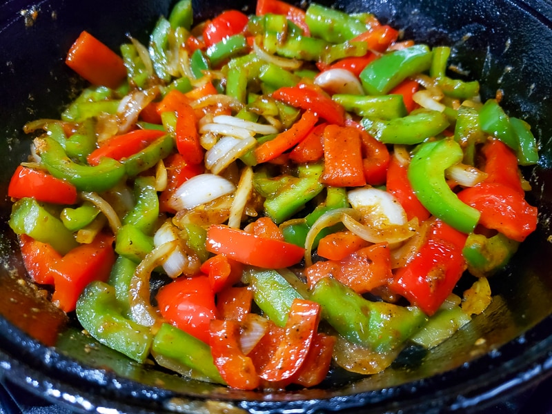 fajita season added to veggies in skillet