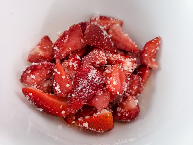 strawberries mixed in a bowl with sugar, lemon juice, and tapioca.