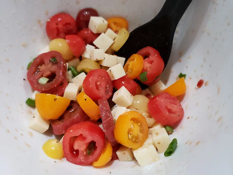 Italian tomato salad mixed in a bowl.