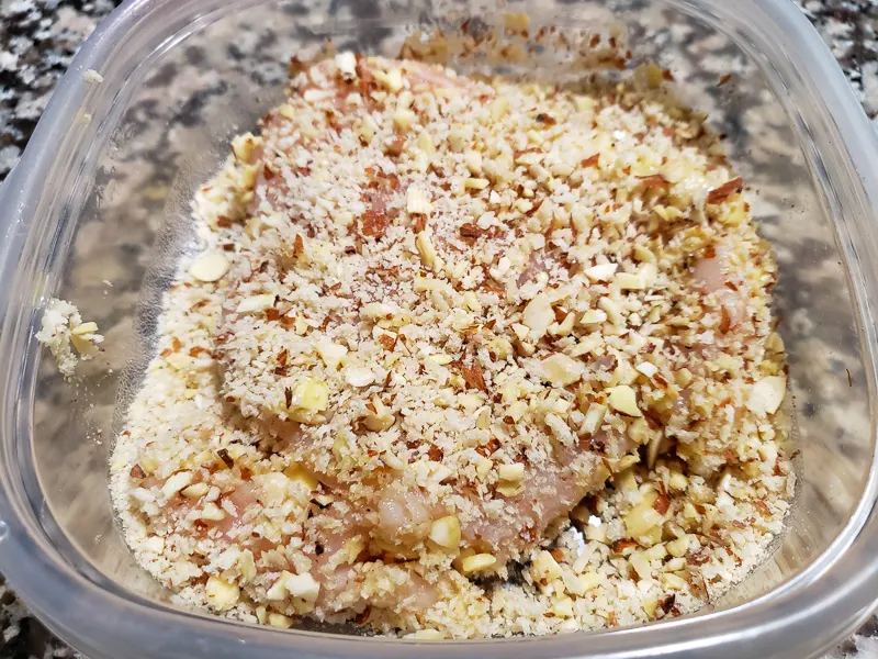 a chicken breast dredged in almond and panko crumbs.