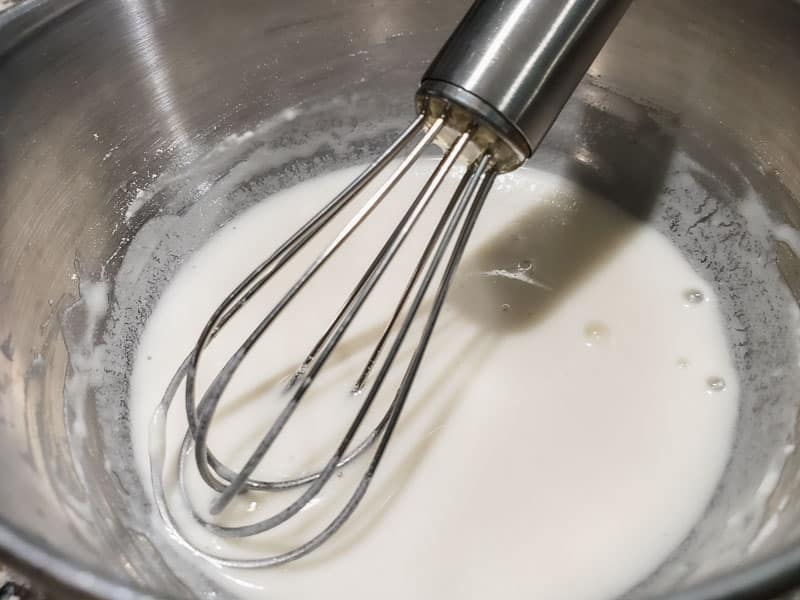 flour and water mixture whisked in a bowl.