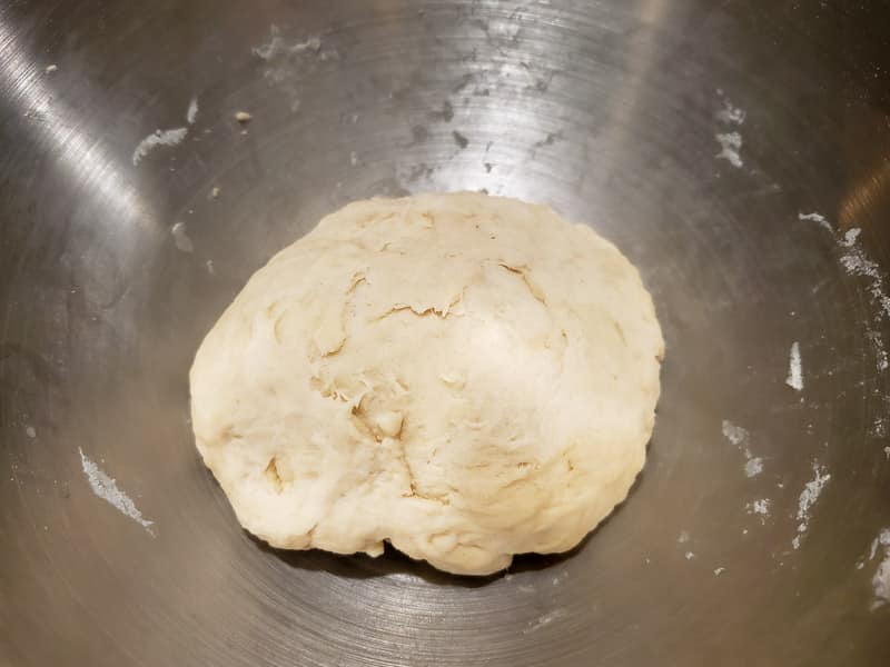 pizza dough resting in a bowl