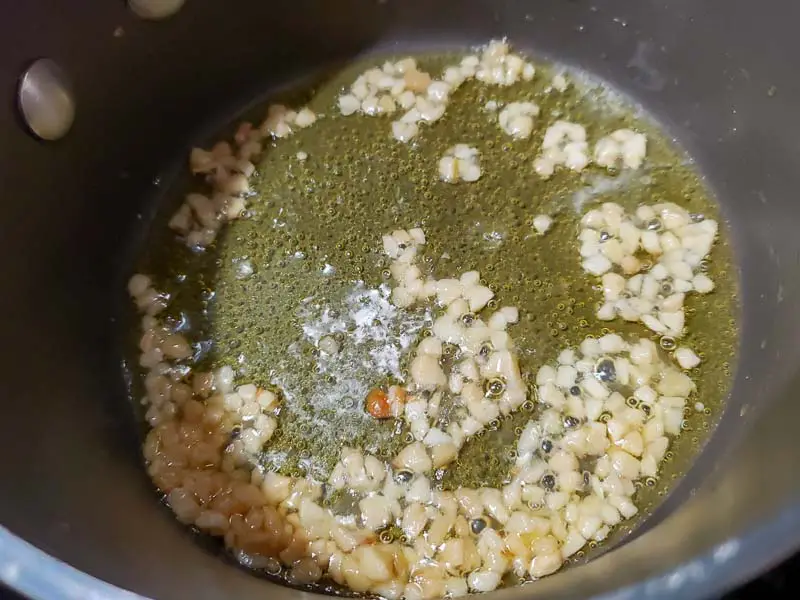 garlic and olive oil cooking in a pan