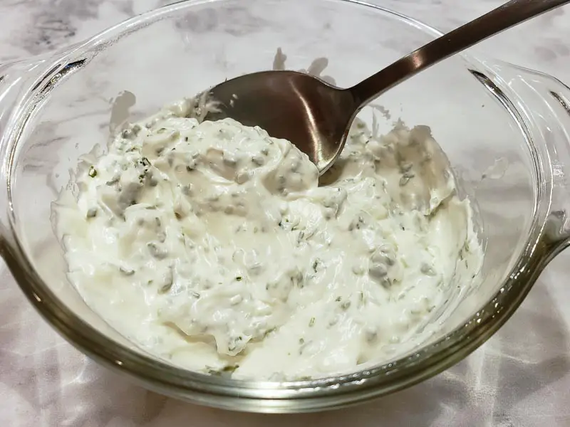 cream cheese mixed in a bowl with chives.