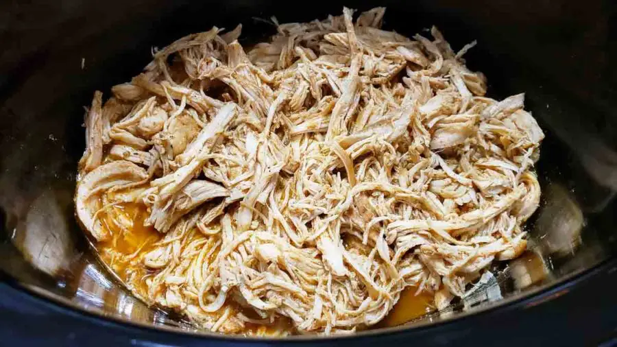 shredded taco chicken in a slow cooker.