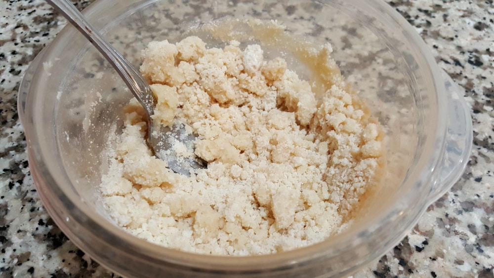crumbly flour, butter, and salt in a bowl.