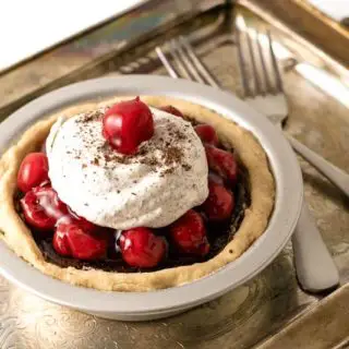 black forest pie on a tarnished tray with two forks