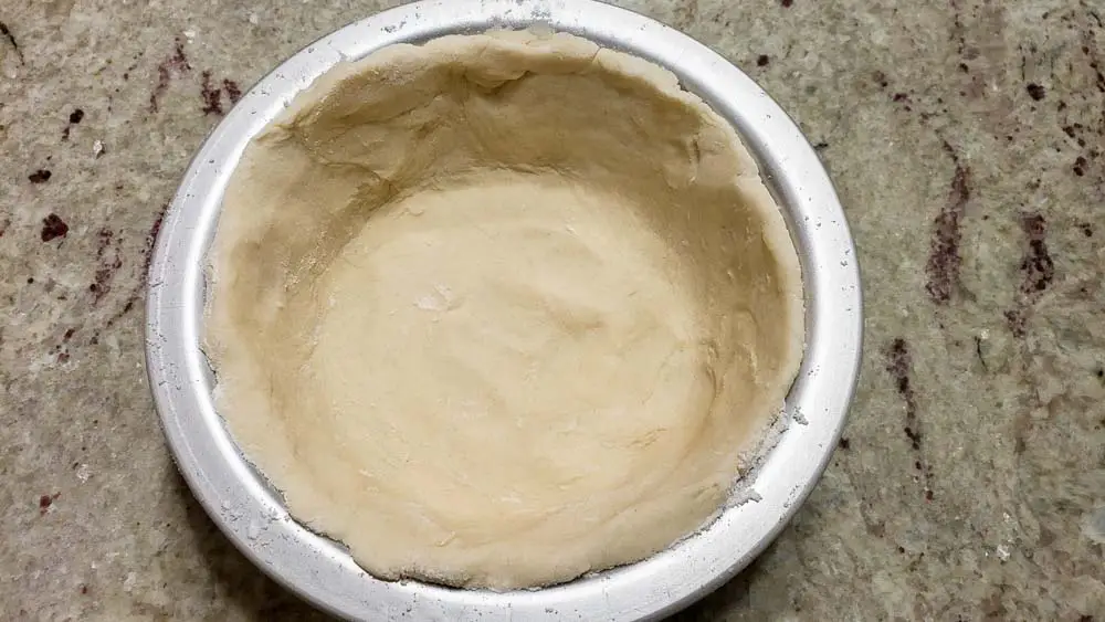 pie crust dough pressed into a pie pan.