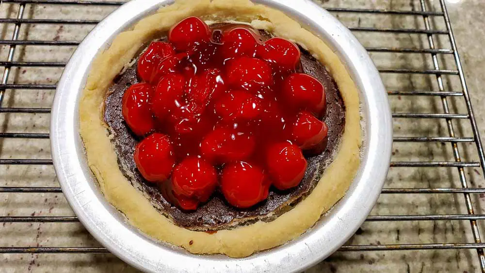 Black Forest Cherry Pie on a wire rack.