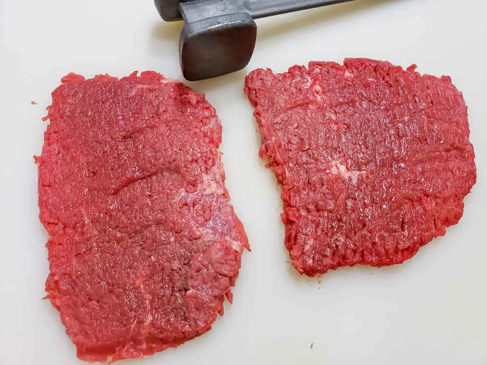 two cube steaks pounded thin.