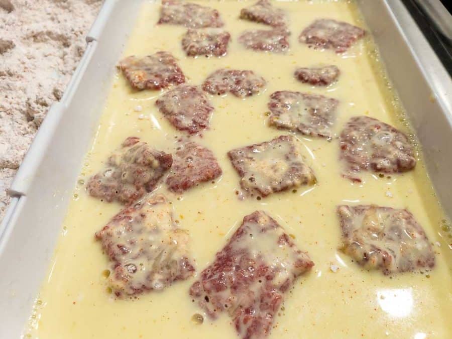 steak cubes dredged in egg mixture