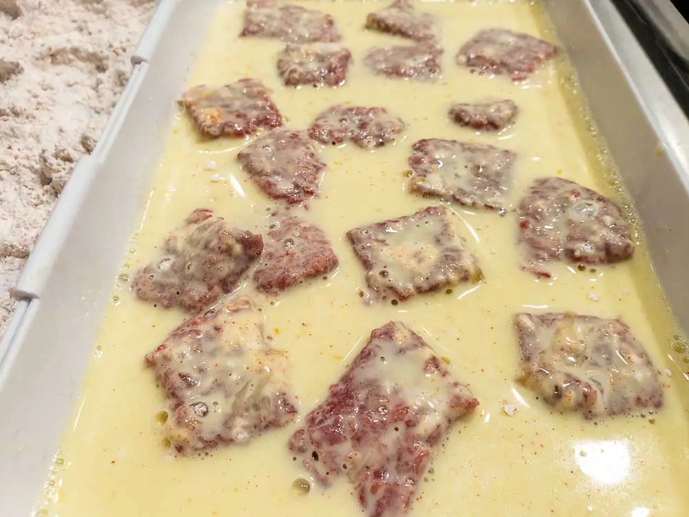 steak cubes dredged in egg mixture.