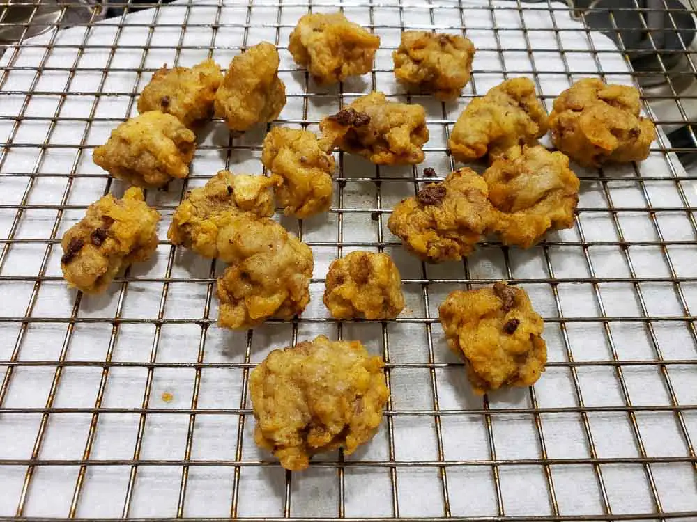 Deep Fried Steak Bites draining on a rack over paper towel.