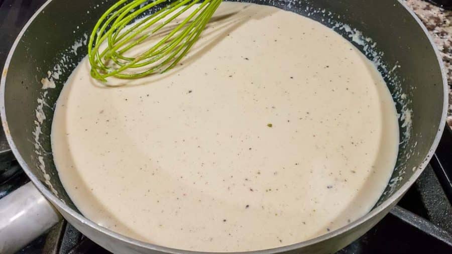 milk added to the flour mixture in a pan