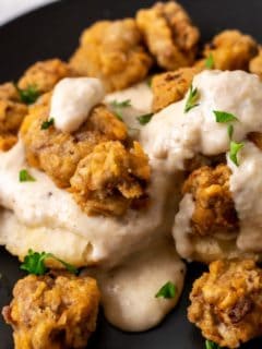 Chicken Fried Steak Bites and Pepper Gravy with Homemade Biscuits on a plate.