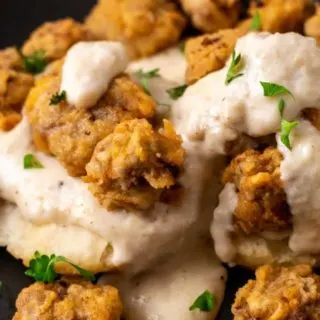 Chicken Fried Steak Bites and Pepper Gravy with Homemade Biscuits on a plate.